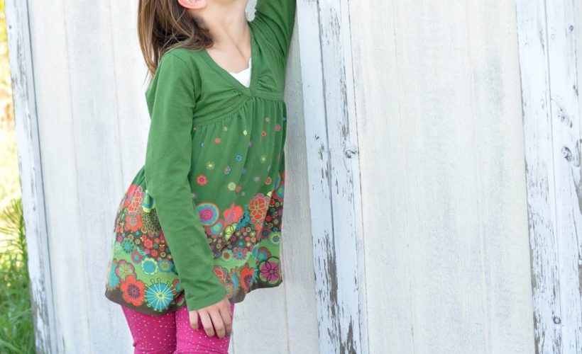 Girl reaching hand up high by old shed by Katie M. Reid Photography