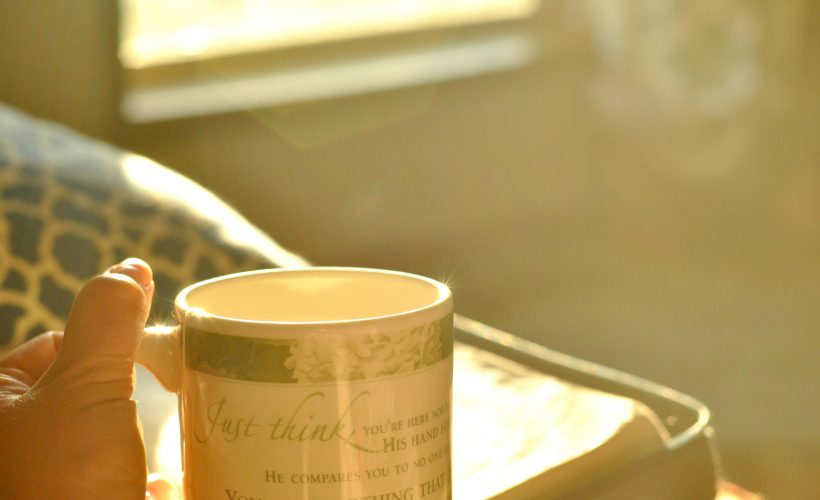 Holding tea mug at sunrise by Katie M Reid Photography